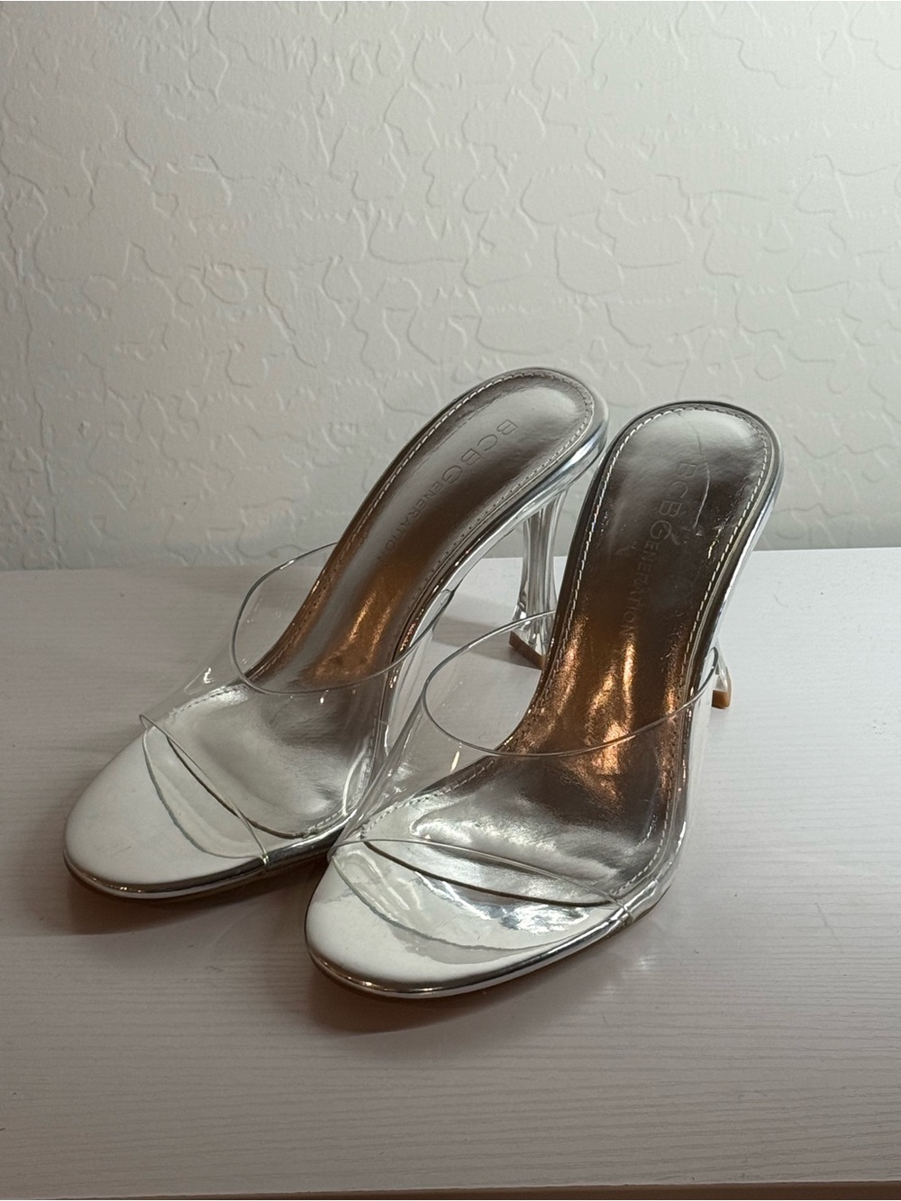 BCBGeneration Clear Strap Silver Mule Heels